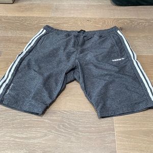 Classic grey adidas three stripes shorts .